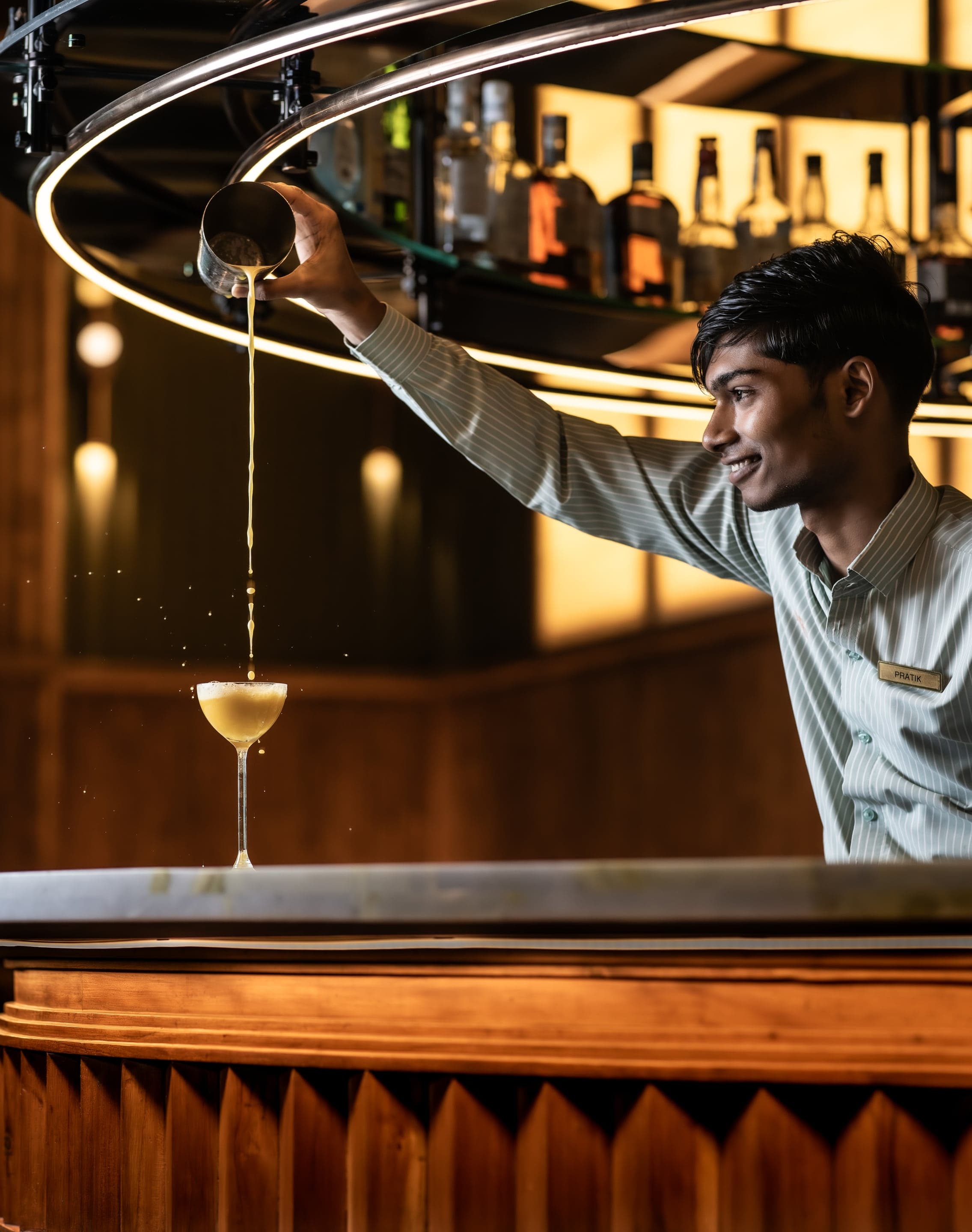 MURO bar counter under hanging brass lights